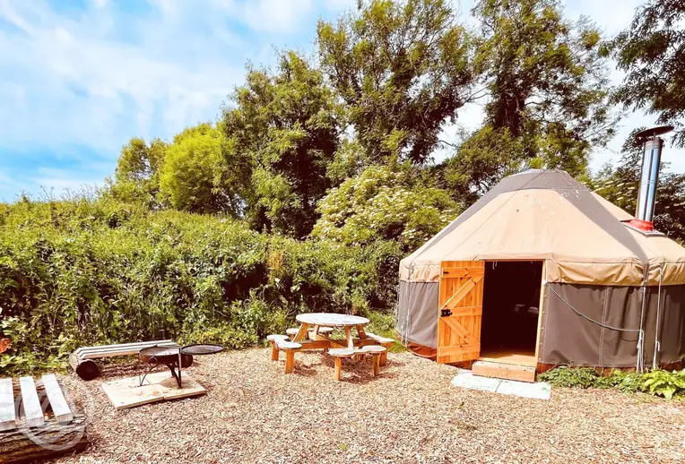 Yurt with outdoor seating area and fire pit