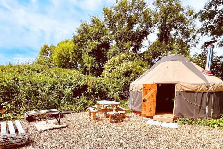 Yurt with outdoor seating area and fire pit
