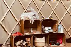 Yurt extra touches including wood, crockery and cutlery