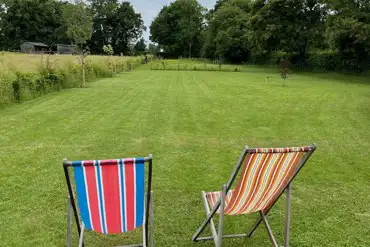 The quiet meadow and deck chairs.