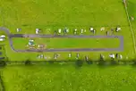 Aerial of grass pitches and track around the site
