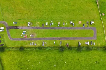 Bird's eye view of grass pitches and track around the site