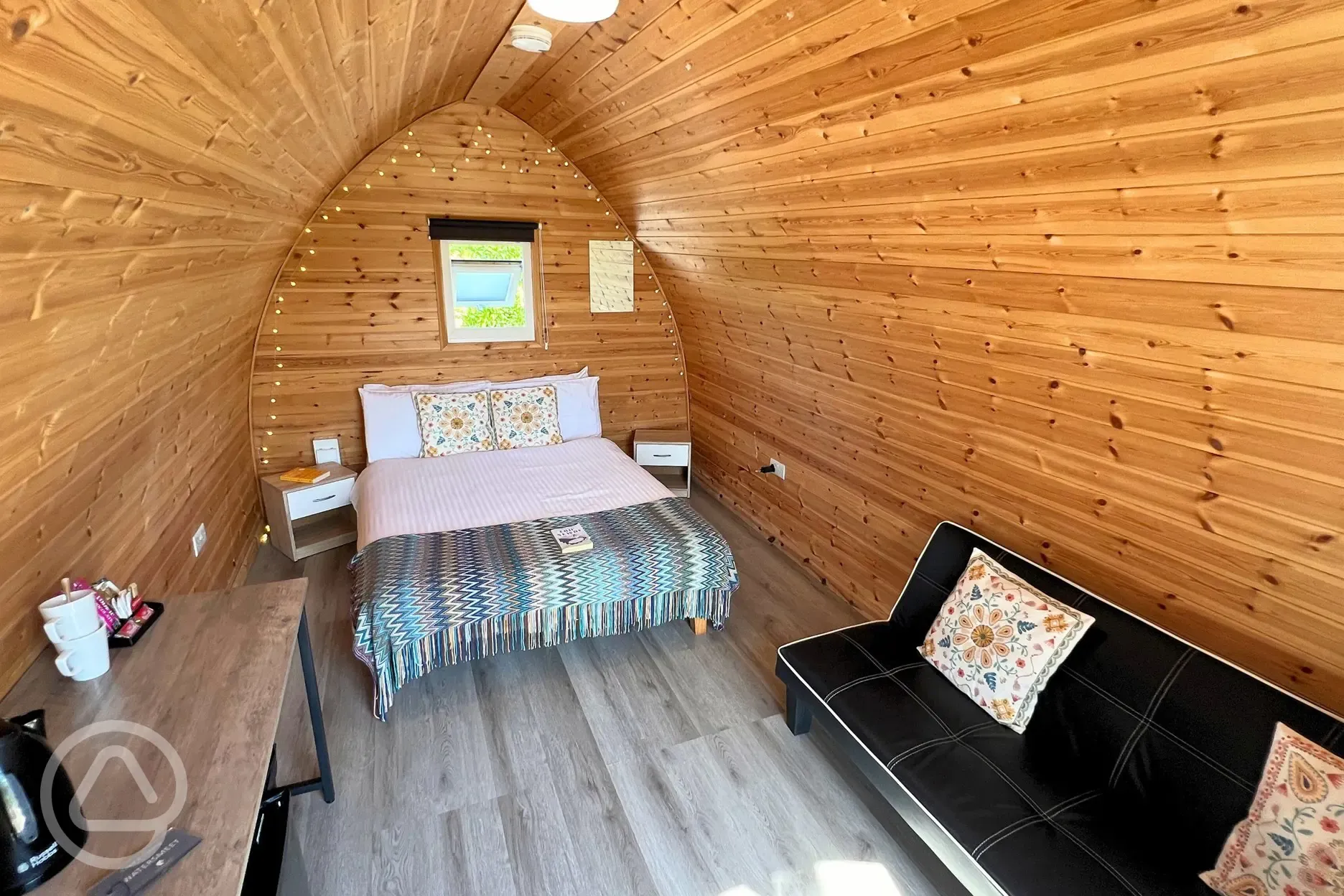 Double bed and sofa in camping pod with valley views interior (pet friendly)