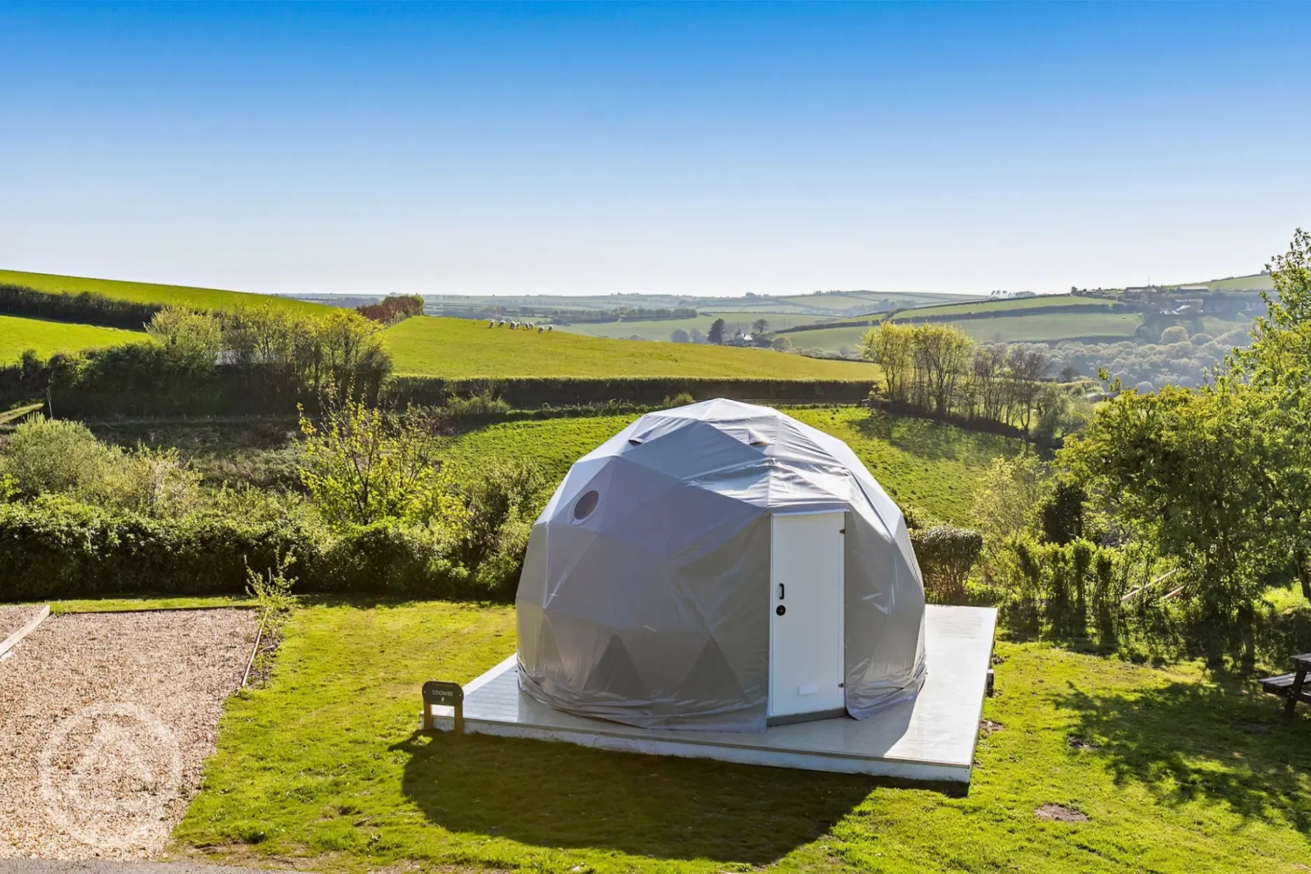 geodome exterior with far reaching countryside views and sheep