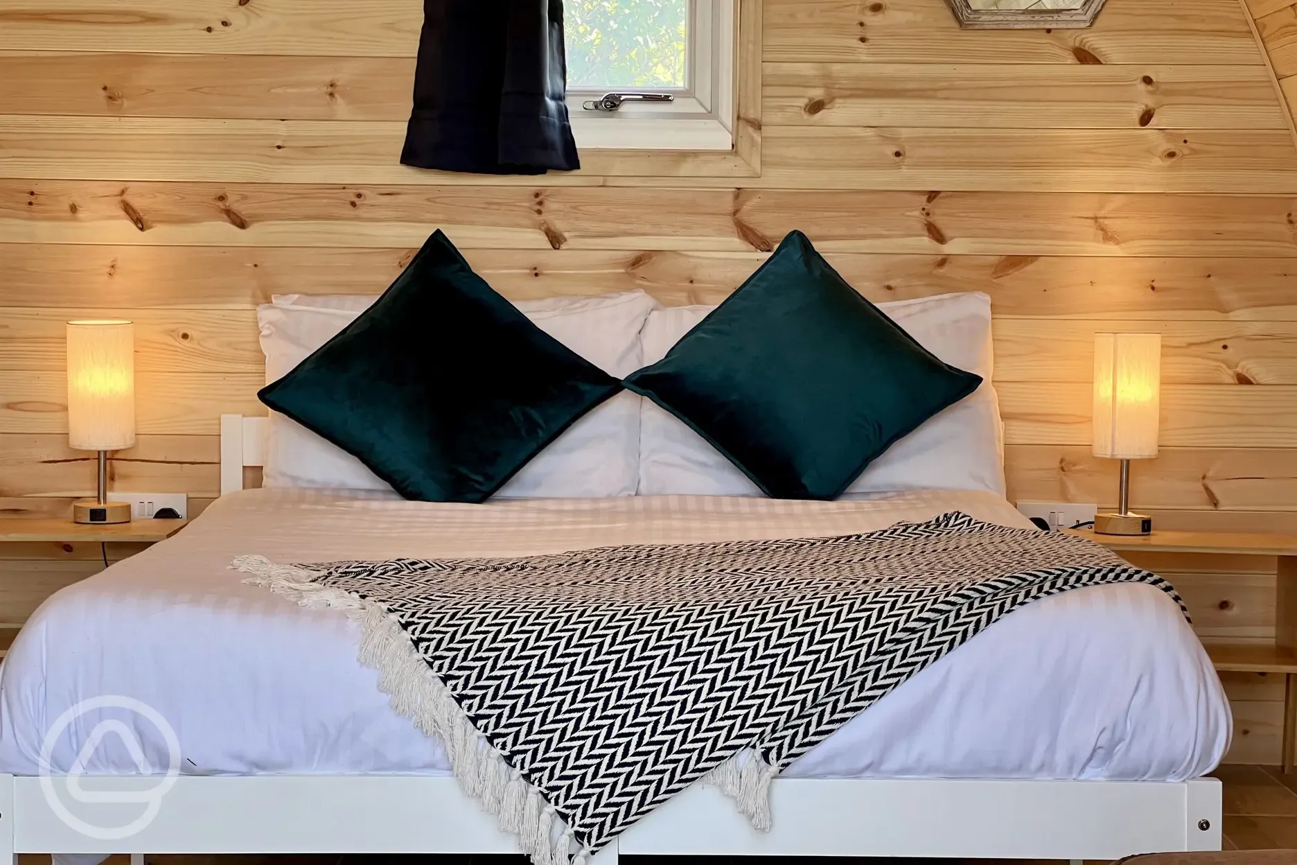 Close up of the double bed in the camping pod with sea views