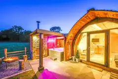 Enterber ensuite glamping pod lit up at night Enterber ensuite glamping pod lit up at night