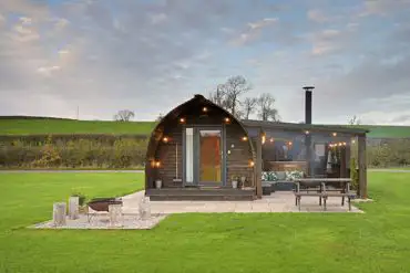 Exterior of Waitby and Greenriggs with fire pits, hot tubs, and private patios