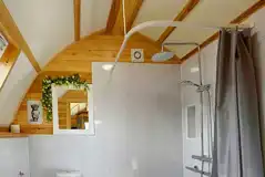 Accessible ensuite shower with a toilet and handwashing sink in the Smardale pod Accessible ensuite shower with a toilet and handwashing sink in the Smardale pod