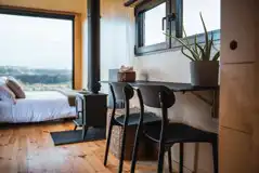 Hare glamping cabin with a double bed, wood burner and seating