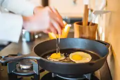 Glamping cabin kitchenette with gas stove, fridge and pans/utensils/crockery