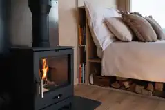 Glamping cabin fire place and bed