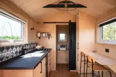 Pheasant glamping cabin kitchenette and breakfast bar seating