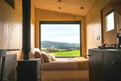 Fox glamping cabin double bed and wood burner