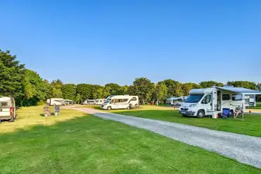 Grass 3m x 8m pitches with 16 amp electric hook ups