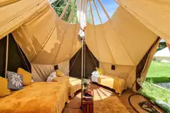 Daisy bell tent interior with a double and four single beds (linen provided) Daisy bell tent interior with a double and four single beds (linen provided)