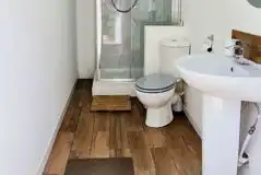 Glamping bathroom with a toilet, shower and sink Glamping bathroom with a toilet, shower and sink