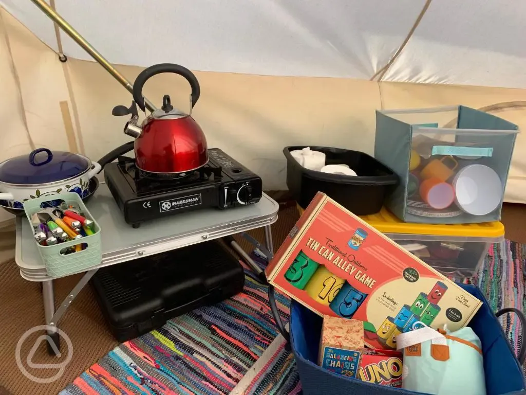 Bell tent kitchen area and games 