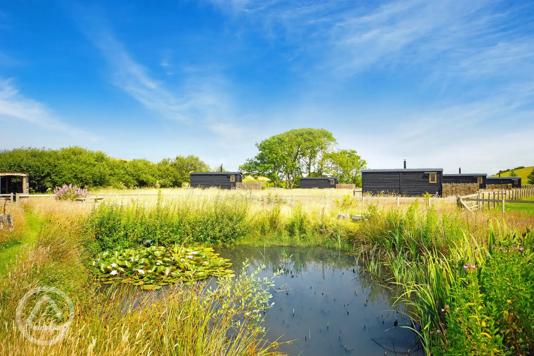 Shepherd's huts by the pond