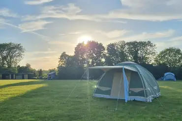 Tent on a grass pitch at Coxhill Camping