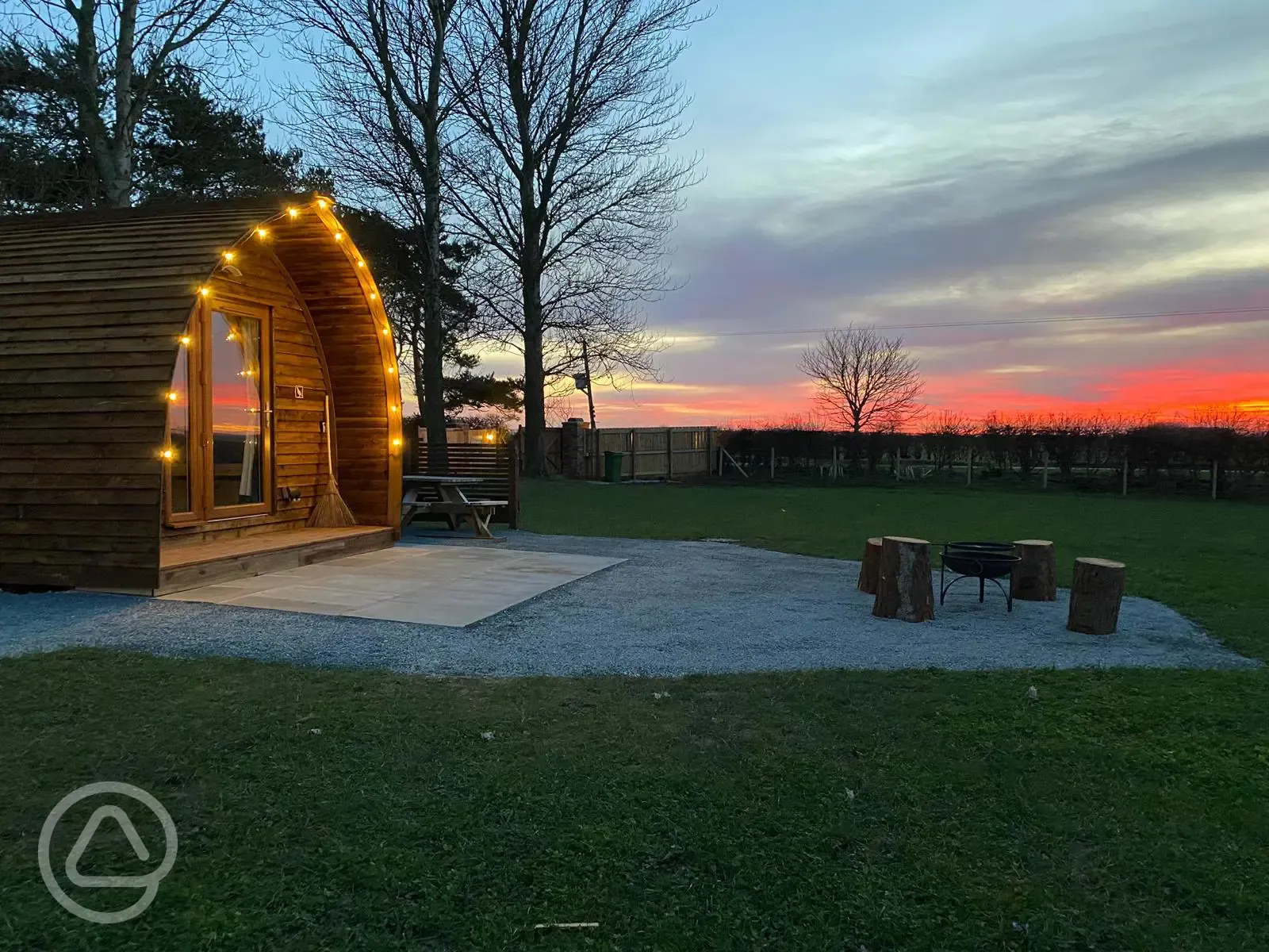 Glamping pods with hot tubs at sunset 