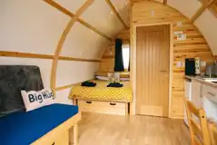 Glamping pod with hot tub interior with a double bed and sofa bed at Little Kelk