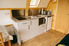 Glamping pod kitchen featuring a fridge/freezer, microwave, toaster, and kettle