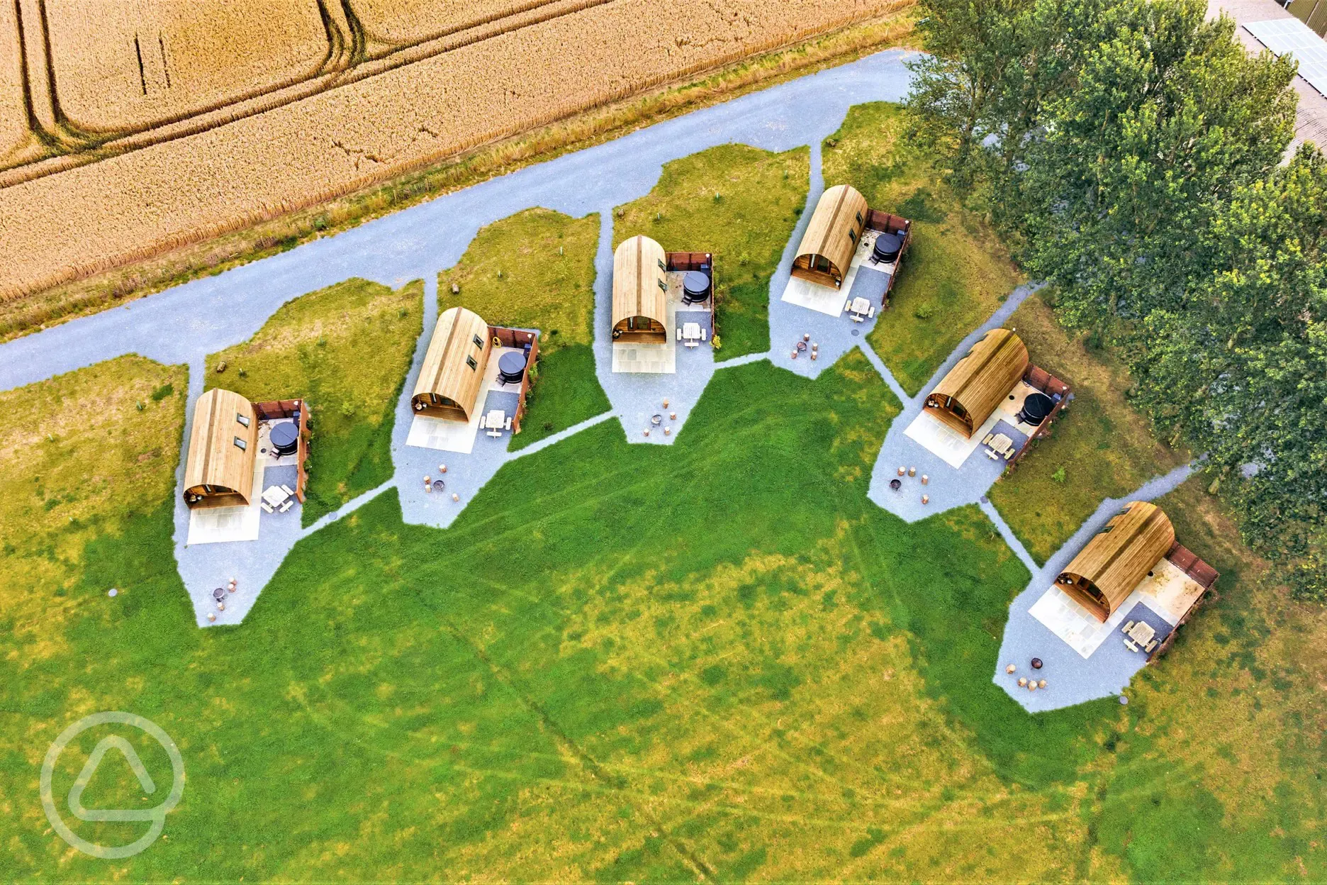 Aerial of glamping pods with hot tubs