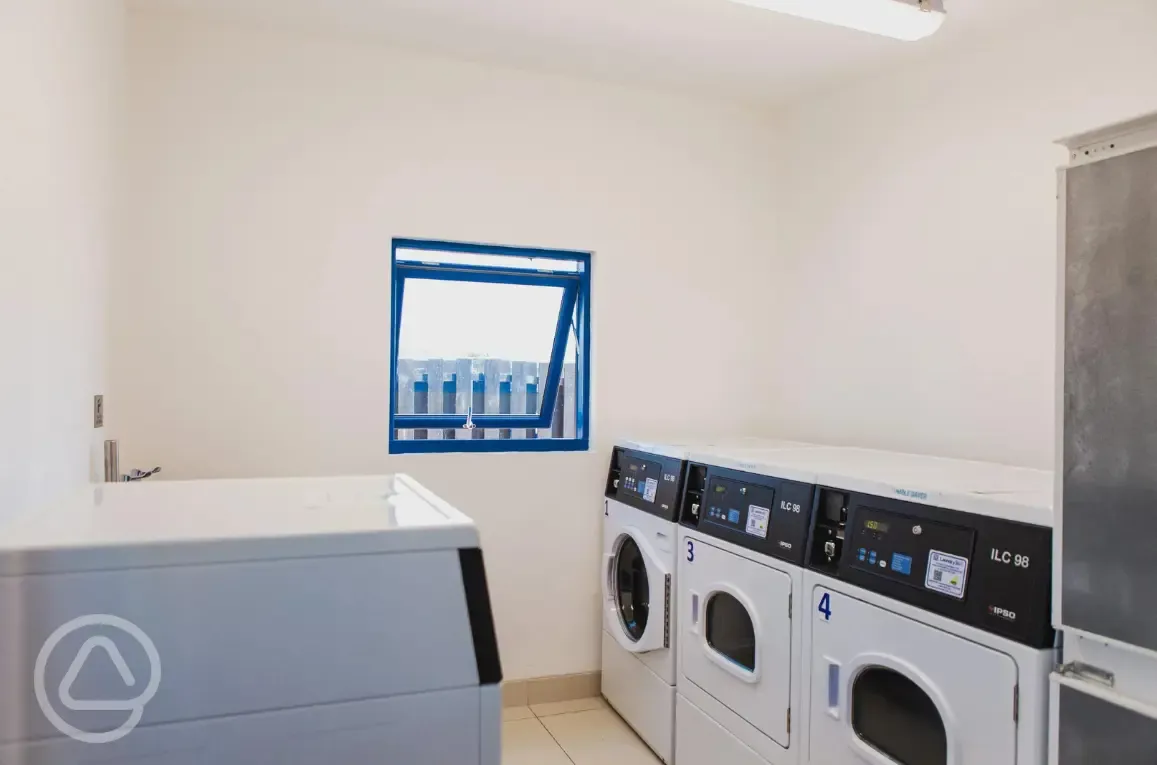Laundry room with washing machines and tumble dryers
