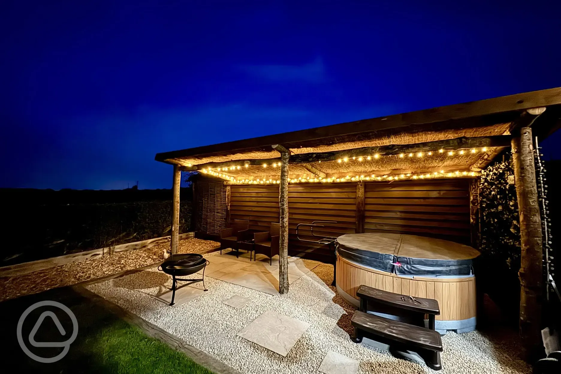 Copper Beech shepherd's hut hot tub at night