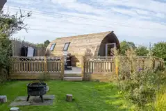 Bowcliffe glamping pod with a lawn area with a fire pit and seating