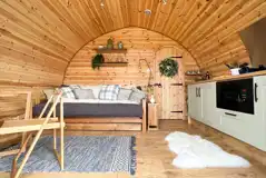 Chaplin's Club pod living area and kitchen area with a double sofa bed