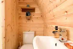 Chaplin's Club pod ensuite with a toilet, shower, hand basin, towels and robes
