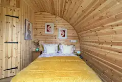 Glencroft pod separate double bedroom with a TV and door to the deck area