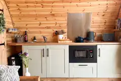 Chaplin's Club kitchen with a microwave, grill, hob, sink and fridge