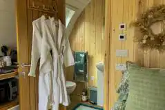 Bowcliffe ensuite bathroom with a toilet, shower, hand basin, towels and robes