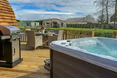 Bowcliffe decking area with an electric hot tub, BBQ and dining set
