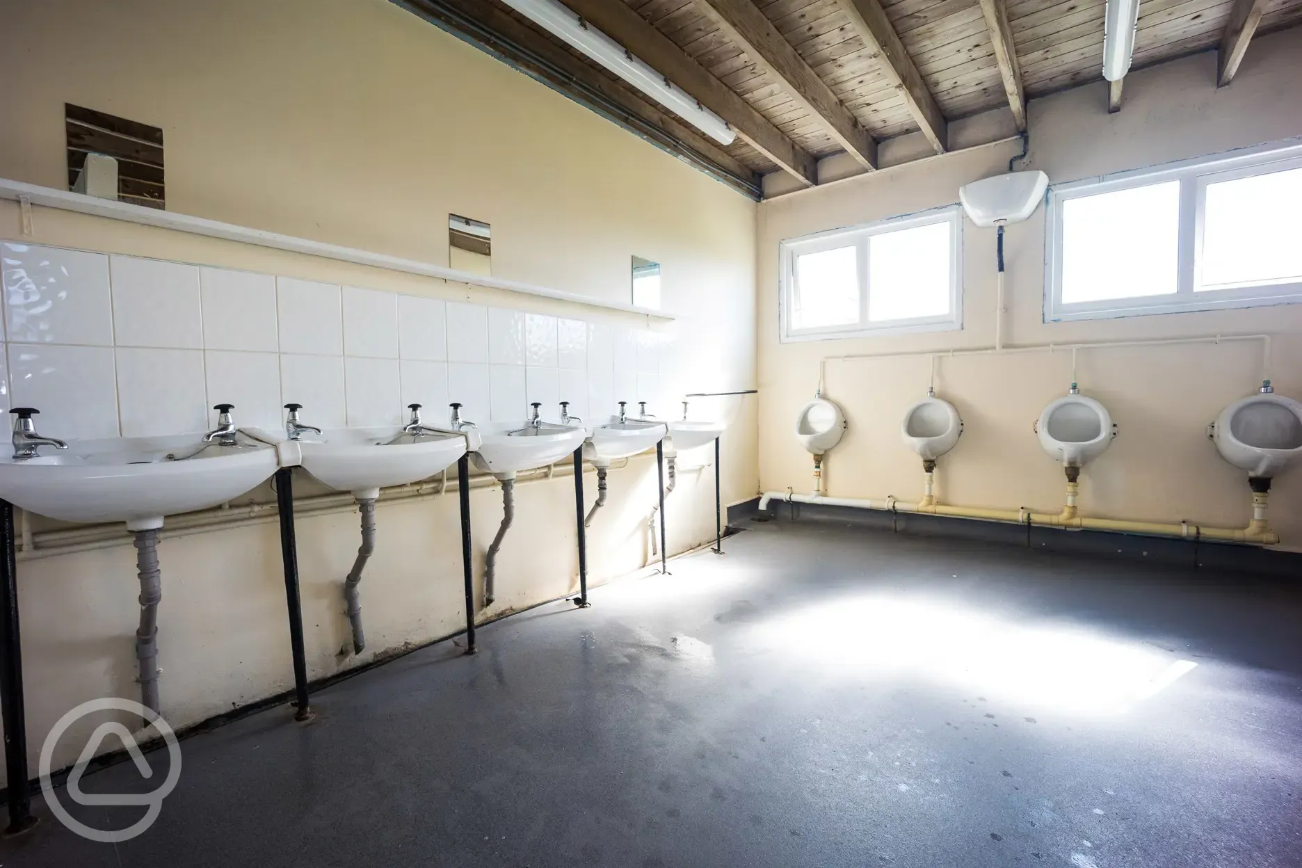 Mens urinals and handwashing sinks in the facility block