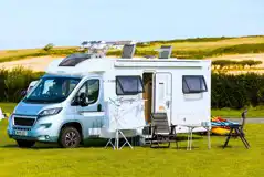 Campervan on non electric grass pitch at West Angle Bay Caravan Park