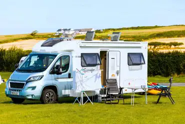 Campervan on non electric grass pitch at West Angle Bay Caravan Park