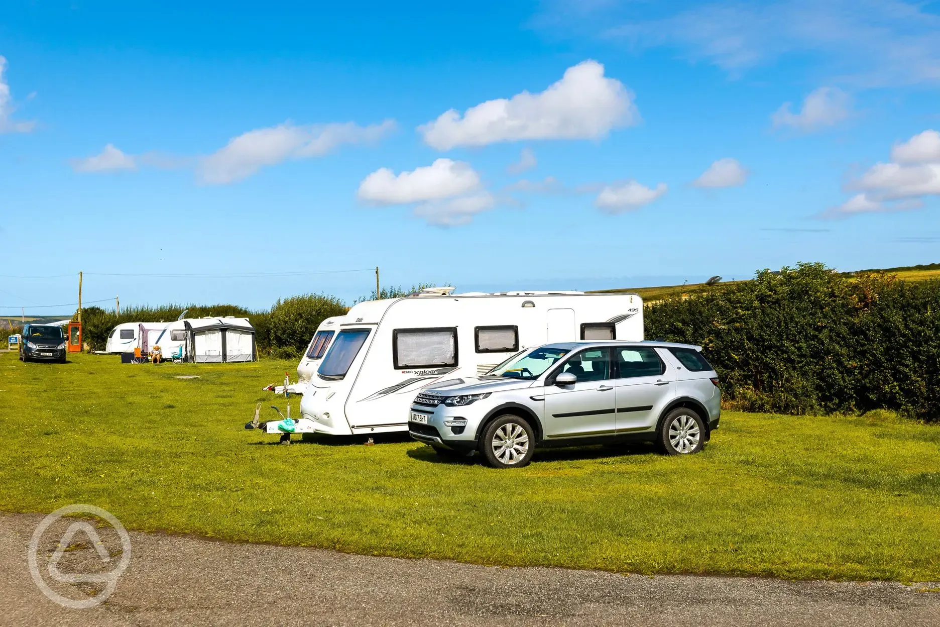 Non electric grass pitches with a car parked next to the pitch