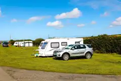 Non electric grass pitches with a car parked next to the pitch