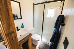 Rusty shepherd's hut ensuite with toilet and shower