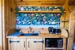 Woodie shepherd's hut kitchenette with microwave, sink, kettle and toaster