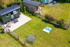 Rusty shepherd's hut exterior with table, chairs and BBQ Rusty shepherd's hut exterior with table, chairs and BBQ
