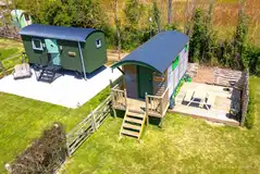 Woodie shepherd's hut exterior with decking area, picnic bench and BBQ