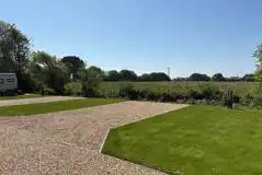 Electric hardstanding touring pitches with a grass area alongside