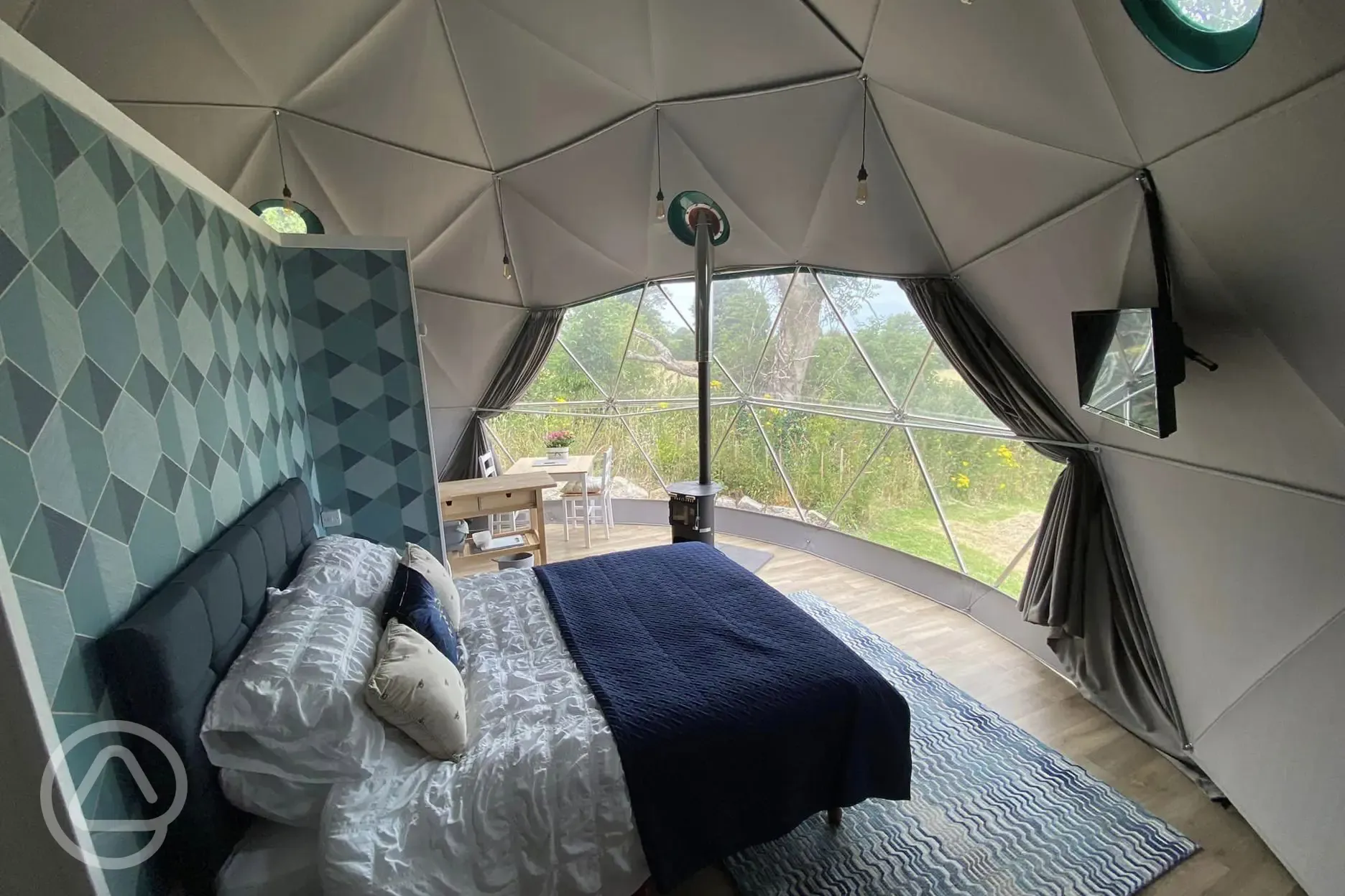 Geodesic dome interior with wood burning stove