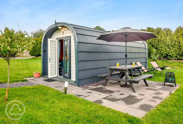 Ensuite glamping pods at Anglesey Holiday Pods with a private patio and seating