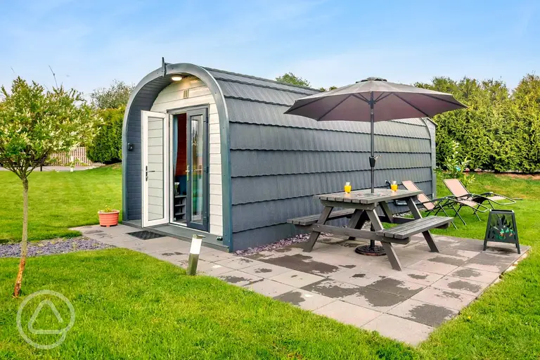 Ensuite glamping pods at Anglesey Holiday Pods with a private patio and seating