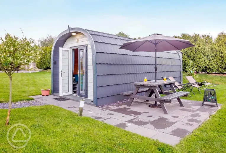 Ensuite glamping pods at Anglesey Holiday Pods with a private patio and seating